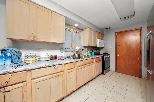a white toilet sitting next to a bathroom sink and tub