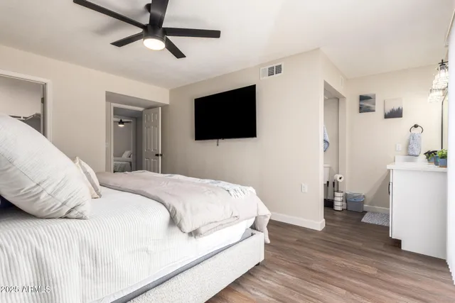 a bedroom with a white bed and white walls