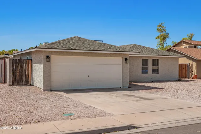 a front view of a house with a garden and garage