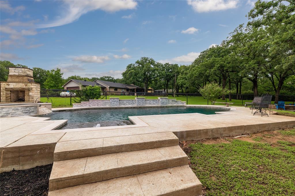 8948 David Fort Road Argyle, TX 76226 - Photo 34 of 39 Custom outdoor pool with integrated spa and water features