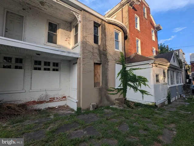 a view of a house with a backyard and a garden