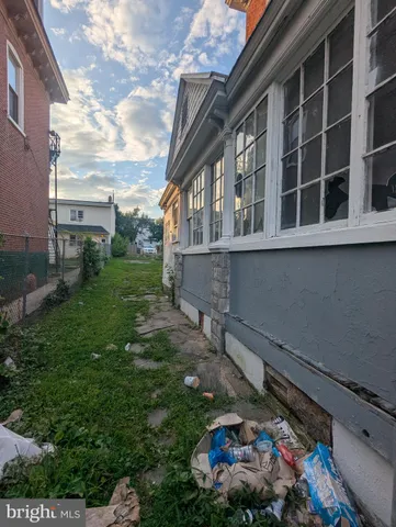 a view of a hallway with wooden floor and entryway