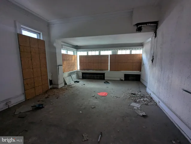 a view of a room with wooden floor and windows