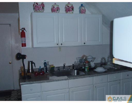 168 Lynd Street Perth Amboy, NJ 08861 - Photo 3 of 8 a kitchen with a sink and cabinets