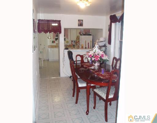 168 Lynd Street Perth Amboy, NJ 08861 - Photo 5 of 8 a dining room with furniture and a chandelier