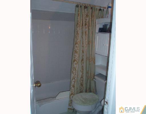 168 Lynd Street Perth Amboy, NJ 08861 - Photo 7 of 8 a bathroom with a shower and a toilet