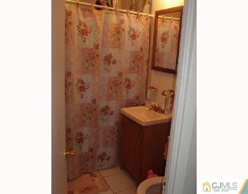 168 Lynd Street Perth Amboy, NJ 08861 - Photo 8 of 8 a bathroom with a sink and mirror