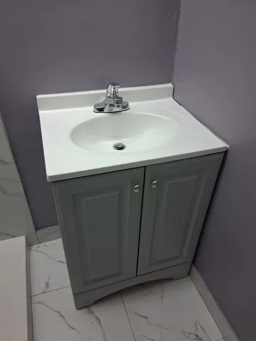 a bathroom with a sink and a mirror