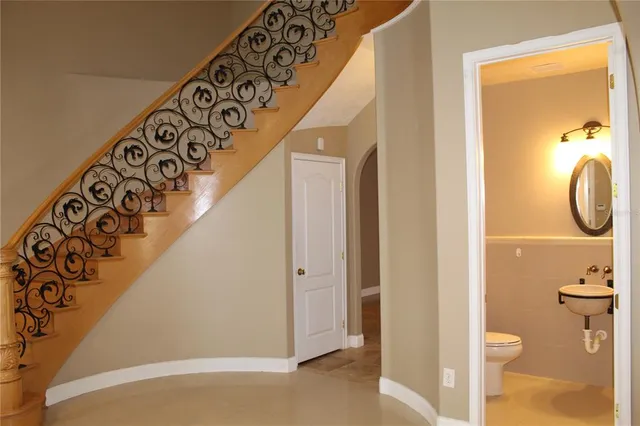 a kitchen with stainless steel appliances granite countertop a sink and a refrigerator