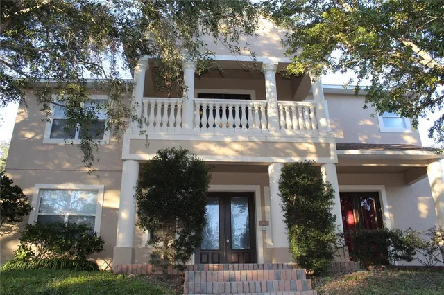 a front view of house with a garden