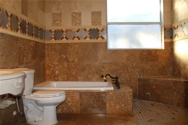 a bathroom with a glass shower door