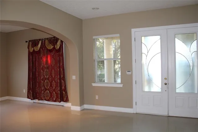a view of a entryway door with furniture and wooden floor