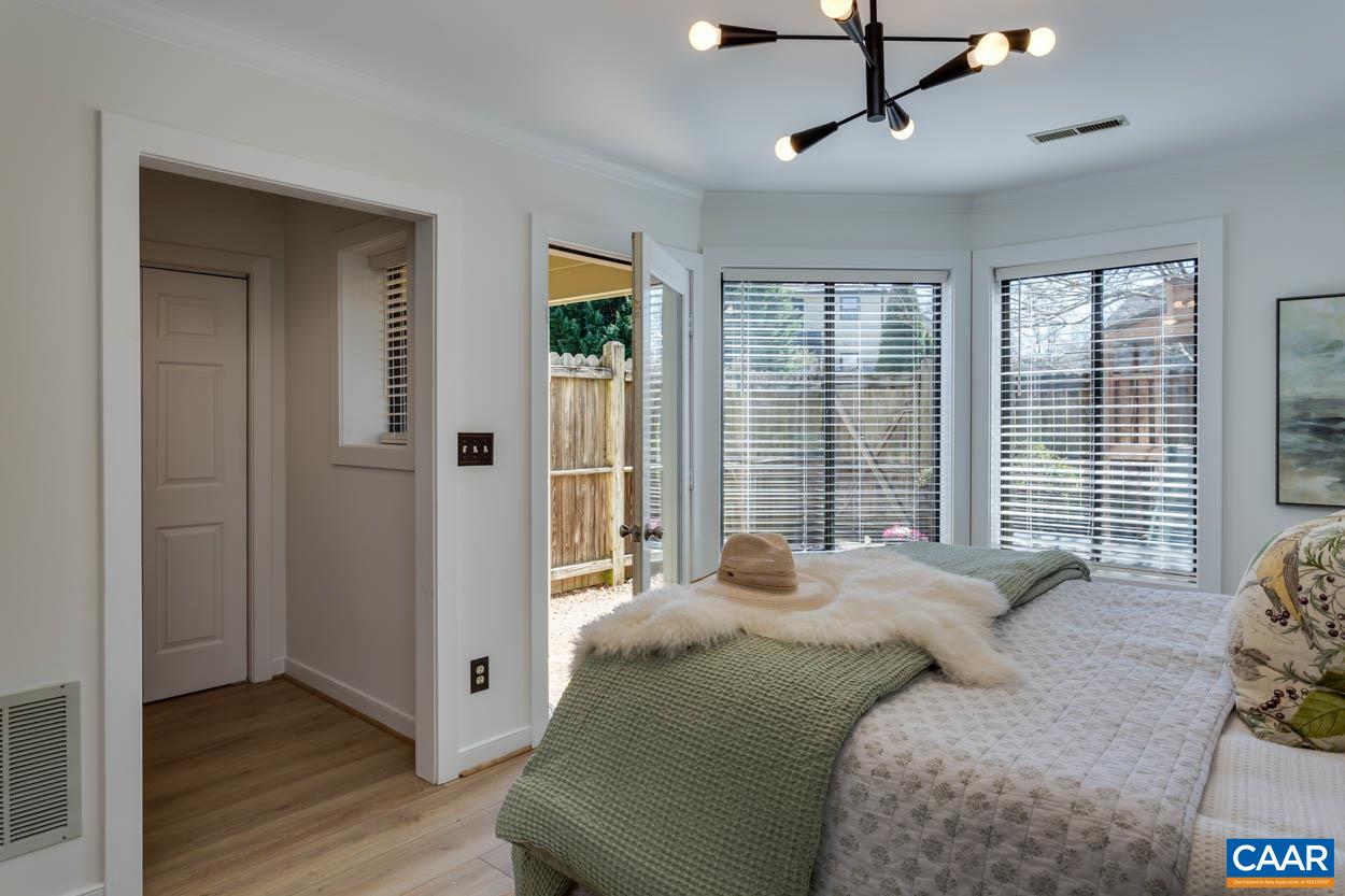 1243 Chatham Ridge Charlottesville, VA 22901 - Photo 12 of 23 a bedroom with a bed closet and flat screen tv