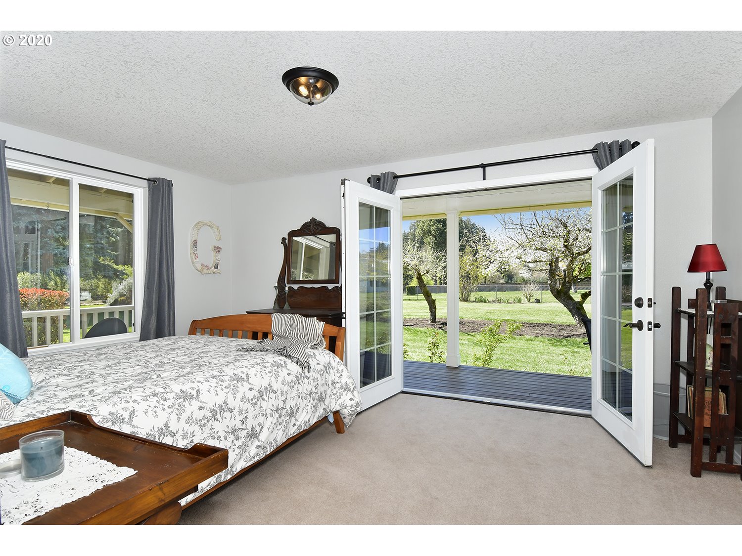 35421 Southeast Gunderson Road Sandy, OR 97055 - Photo 13 of 32 a bedroom with a bed and large windows