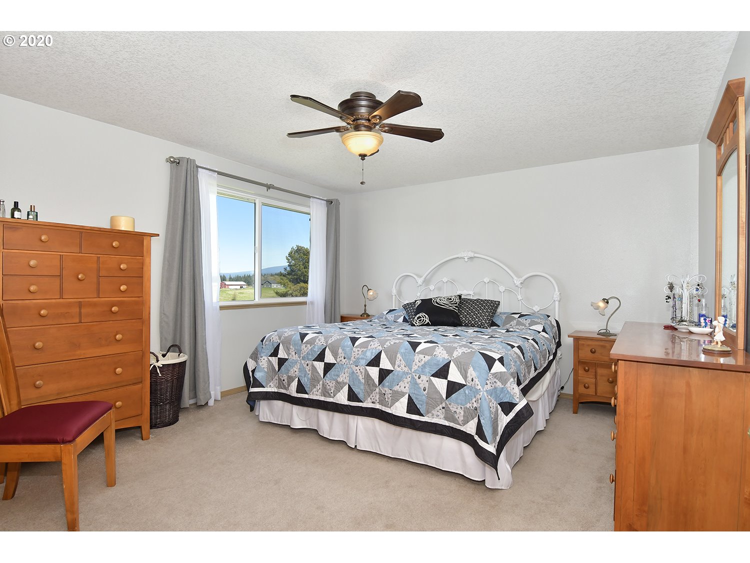 35421 Southeast Gunderson Road Sandy, OR 97055 - Photo 16 of 32 a bed sitting in a bedroom next to a window