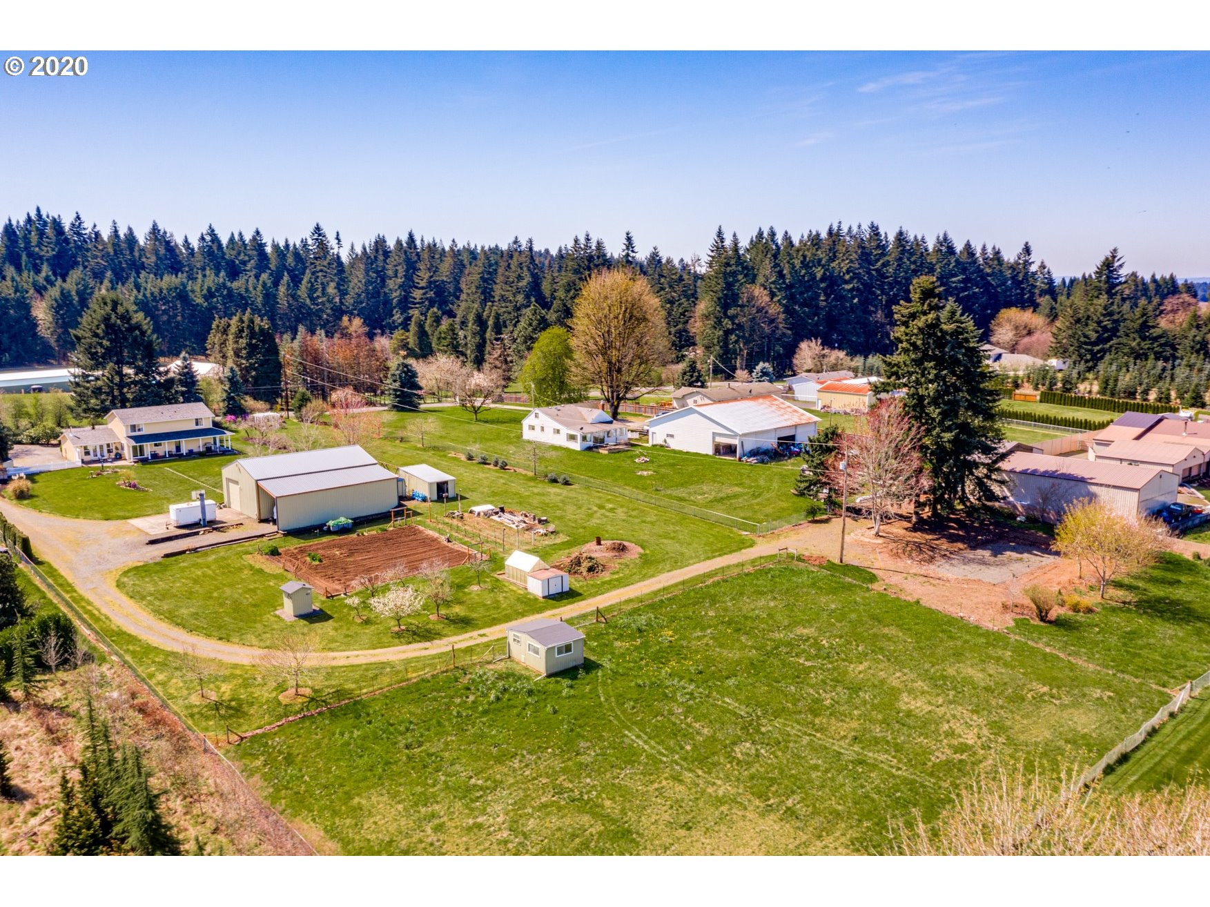 35421 Southeast Gunderson Road Sandy, OR 97055 - Photo 29 of 32 a view of a swimming pool with a garden and a chairs with wooden fence
