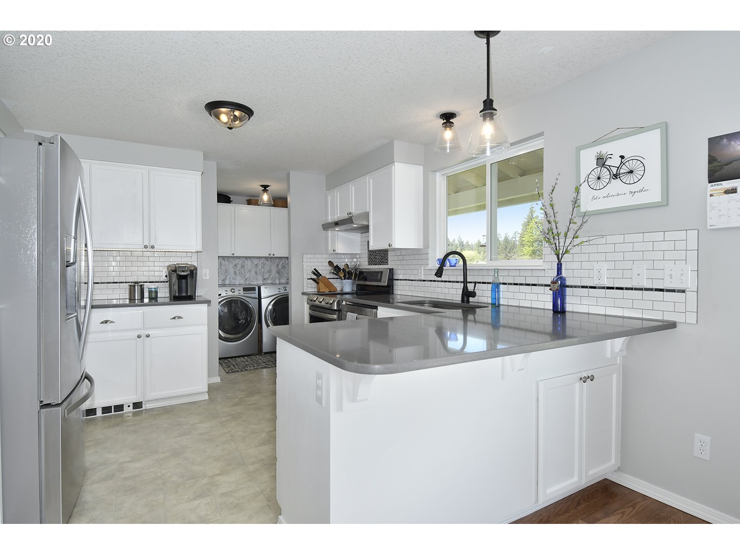 35421 Southeast Gunderson Road Sandy, OR 97055 - Photo 10 of 32 a kitchen with stainless steel appliances granite countertop a sink a stove and a refrigerator