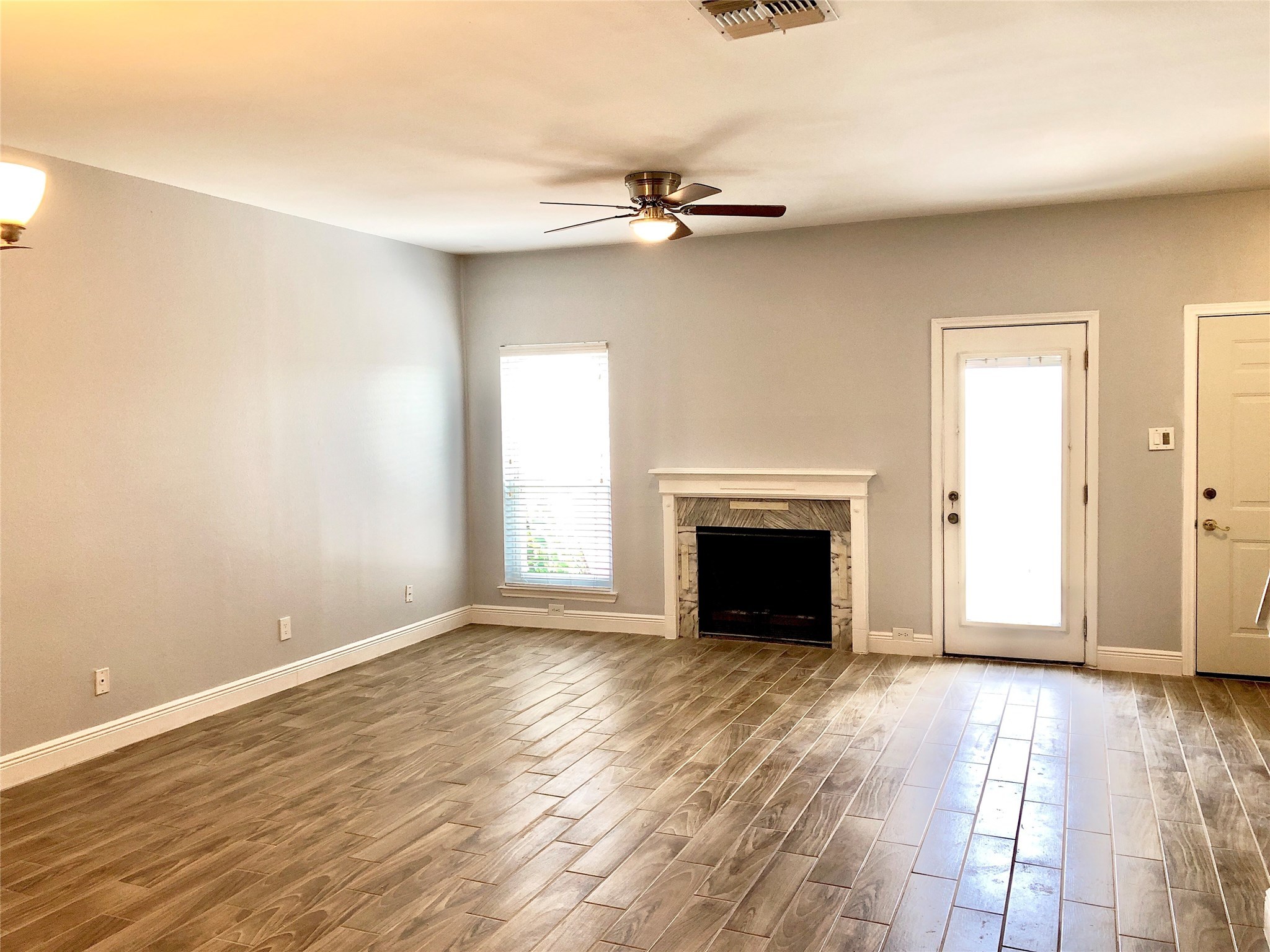 3178 Holly Hall Street Houston, TX 77054 - Photo 4 of 10 wooden floor fireplace and windows in a room
