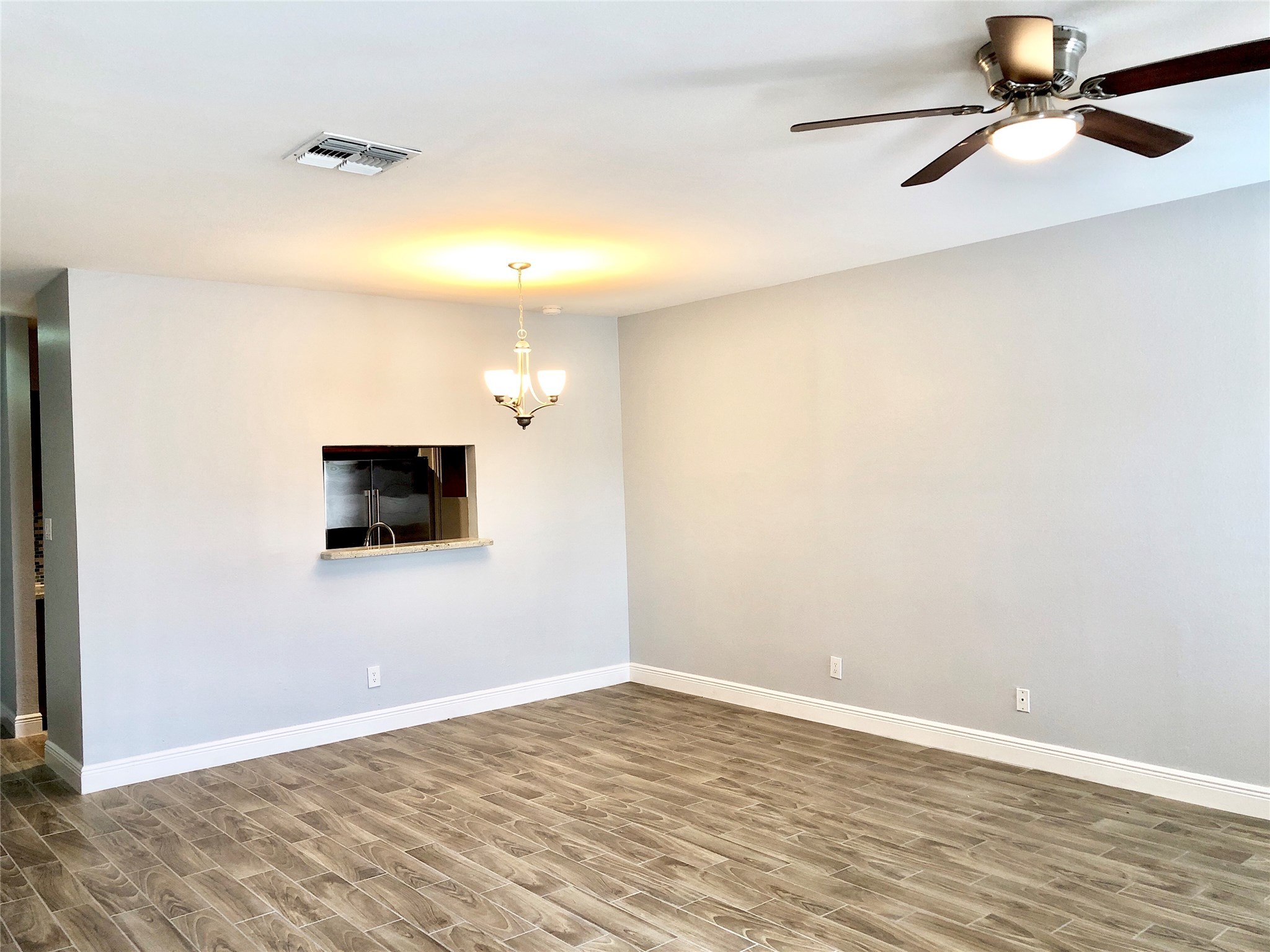 3178 Holly Hall Street Houston, TX 77054 - Photo 5 of 10 a view of an empty room with wooden floor and a window