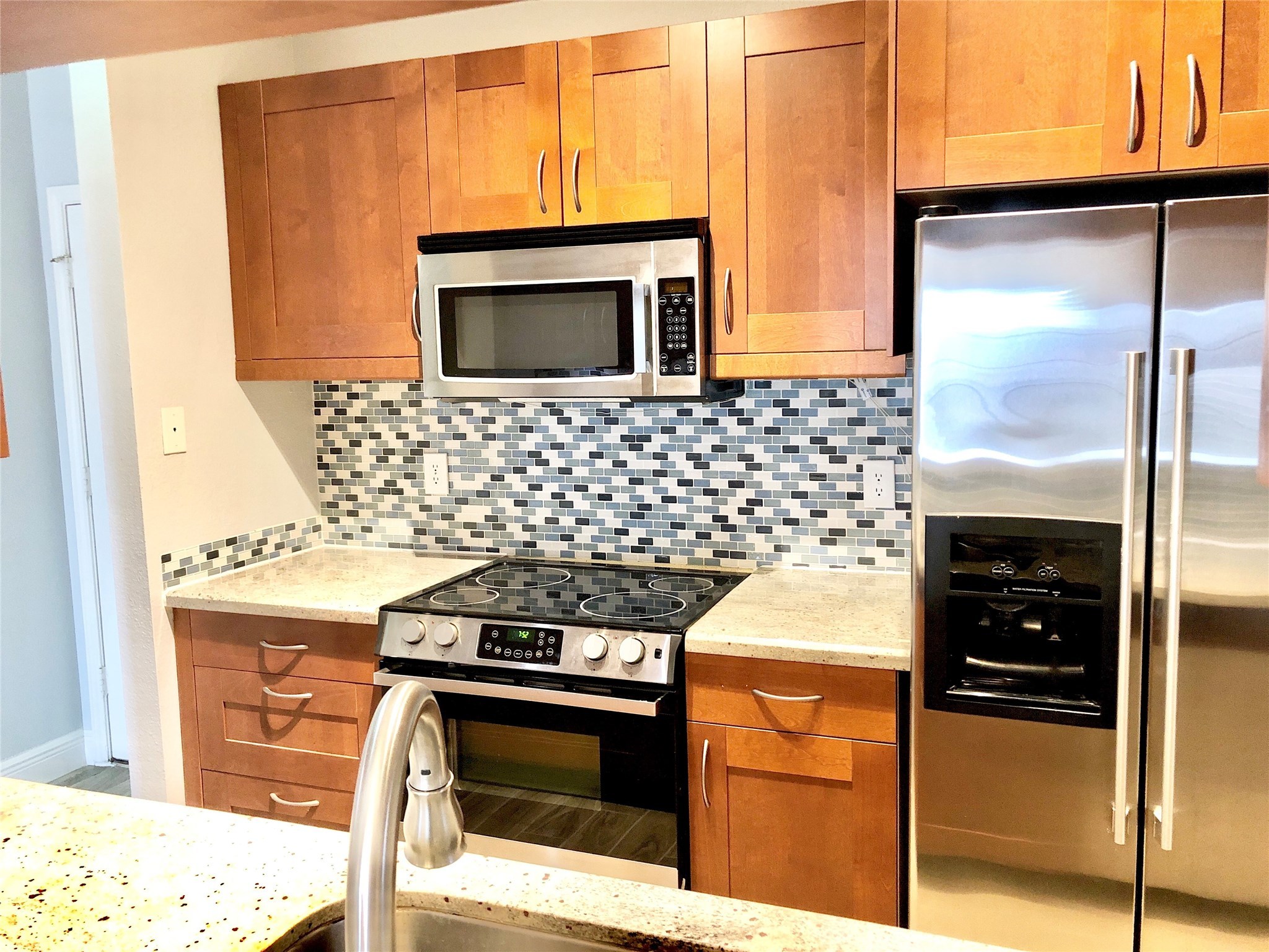 3178 Holly Hall Street Houston, TX 77054 - Photo 7 of 10 a kitchen with a stove and a microwave