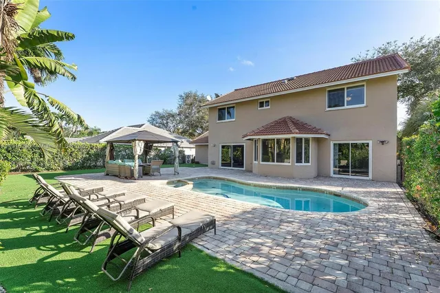 a patio with a table and chairs under an umbrella