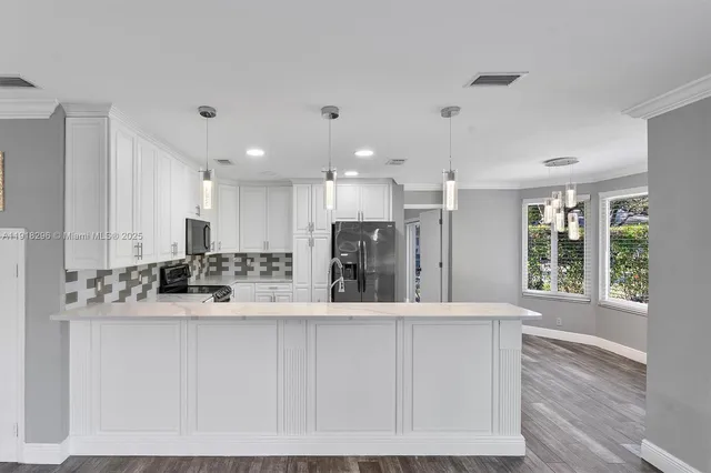a large white kitchen with a large window