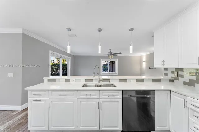 a kitchen with a sink stove and cabinets