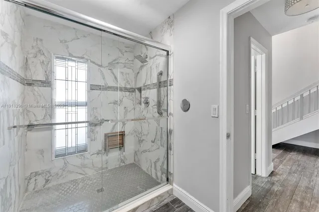 a bathroom with a glass shower door