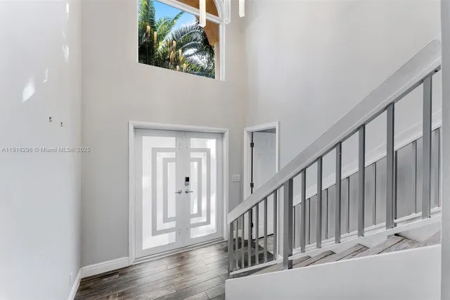 a view of staircase with railing and white walls