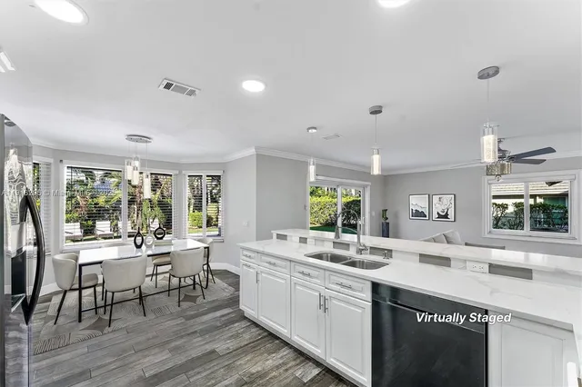 a kitchen with a sink and chairs