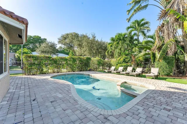 a view of a yard with swimming pool