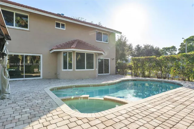 a view of a house with pool in backyard