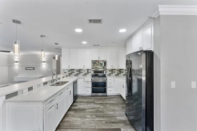 a kitchen with refrigerator and cabinets