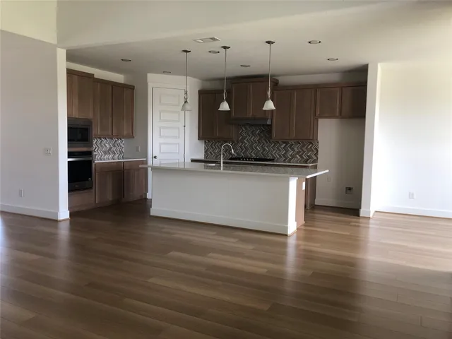 a view of a kitchen with a sink and a stove top oven