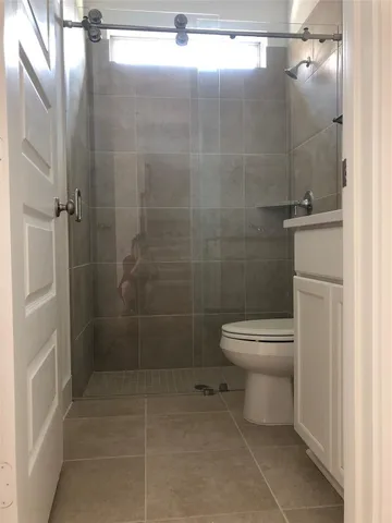 a bathroom with a toilet and a shower