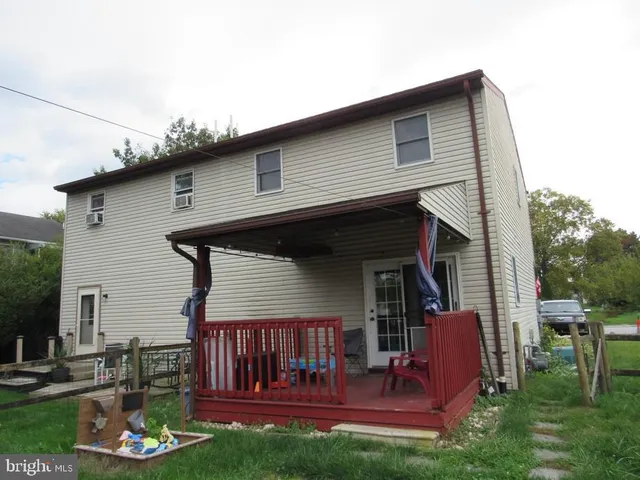a front view of house with yard barbeque oven and outdoor seating