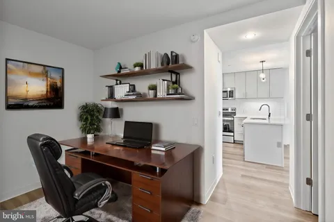 a view of a workspace with furniture and a flat screen tv