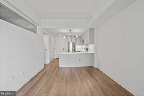 a view of kitchen with wooden floor and window