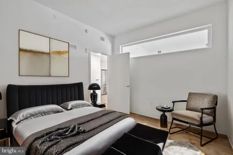 a bedroom with a bed and a mirror