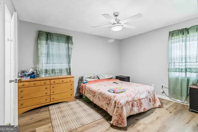 a bedroom with a large bed and a chandelier