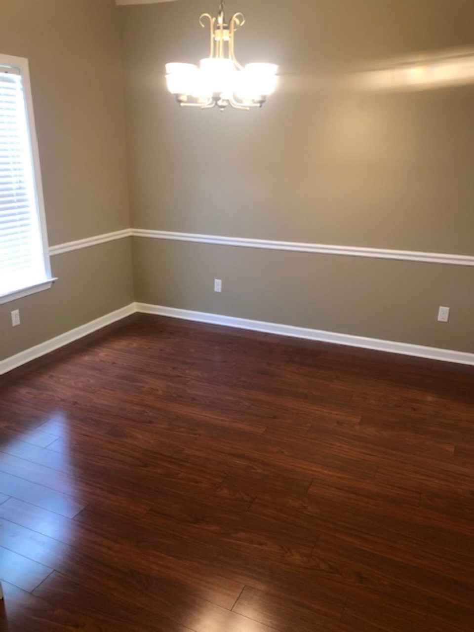 1386 Milestone Circle Collierville, TN 38017 - Photo 3 of 16 a view of an empty room with wooden floor and a window