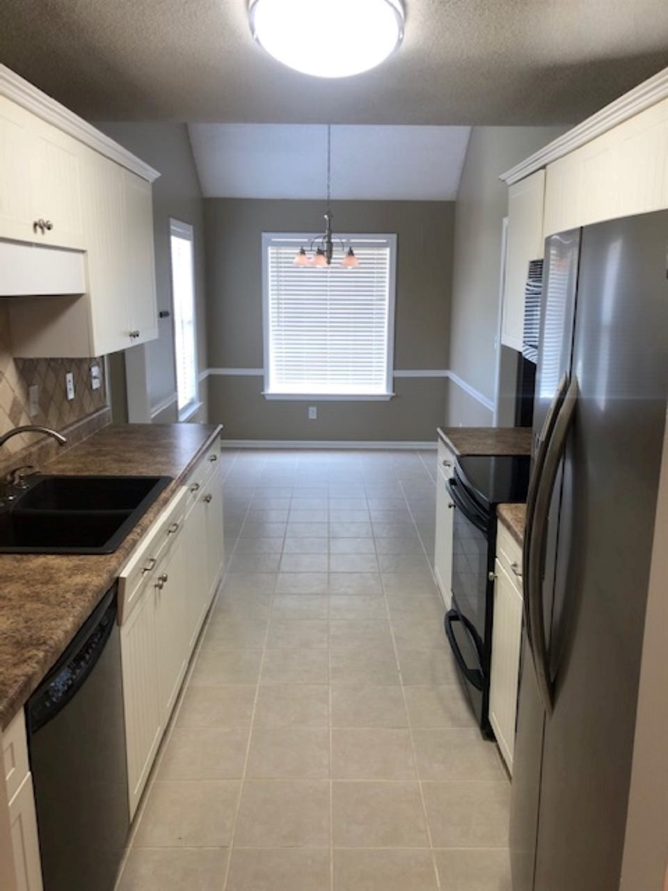 1386 Milestone Circle Collierville, TN 38017 - Photo 4 of 16 a kitchen with stainless steel appliances granite countertop a sink a stove a refrigerator and island