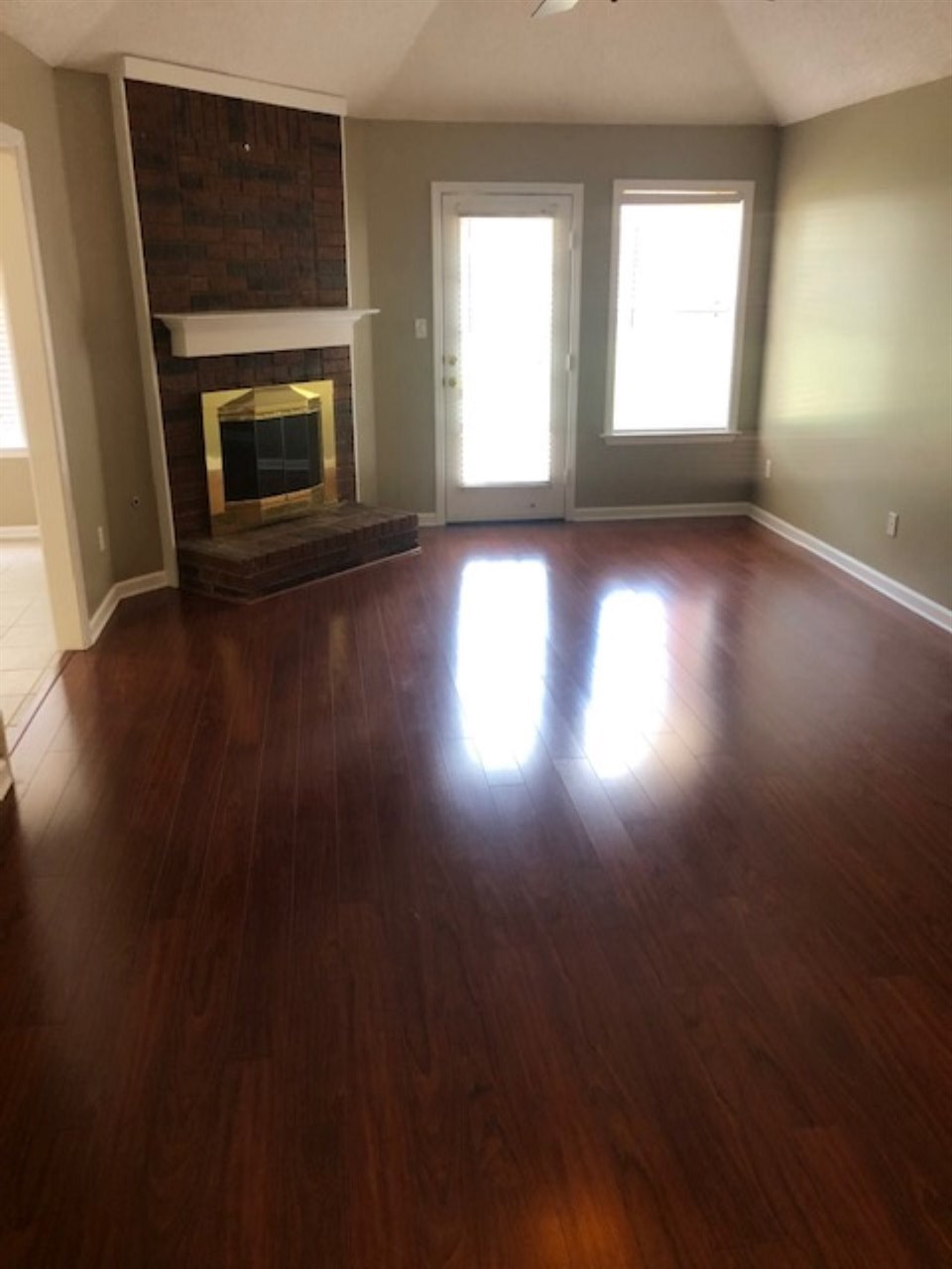 1386 Milestone Circle Collierville, TN 38017 - Photo 5 of 16 an empty room with wooden floor fire place and windows