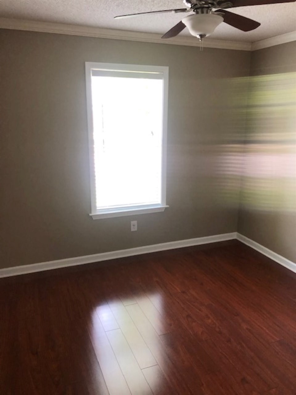 1386 Milestone Circle Collierville, TN 38017 - Photo 8 of 16 a view of an empty room with wooden floor and a window