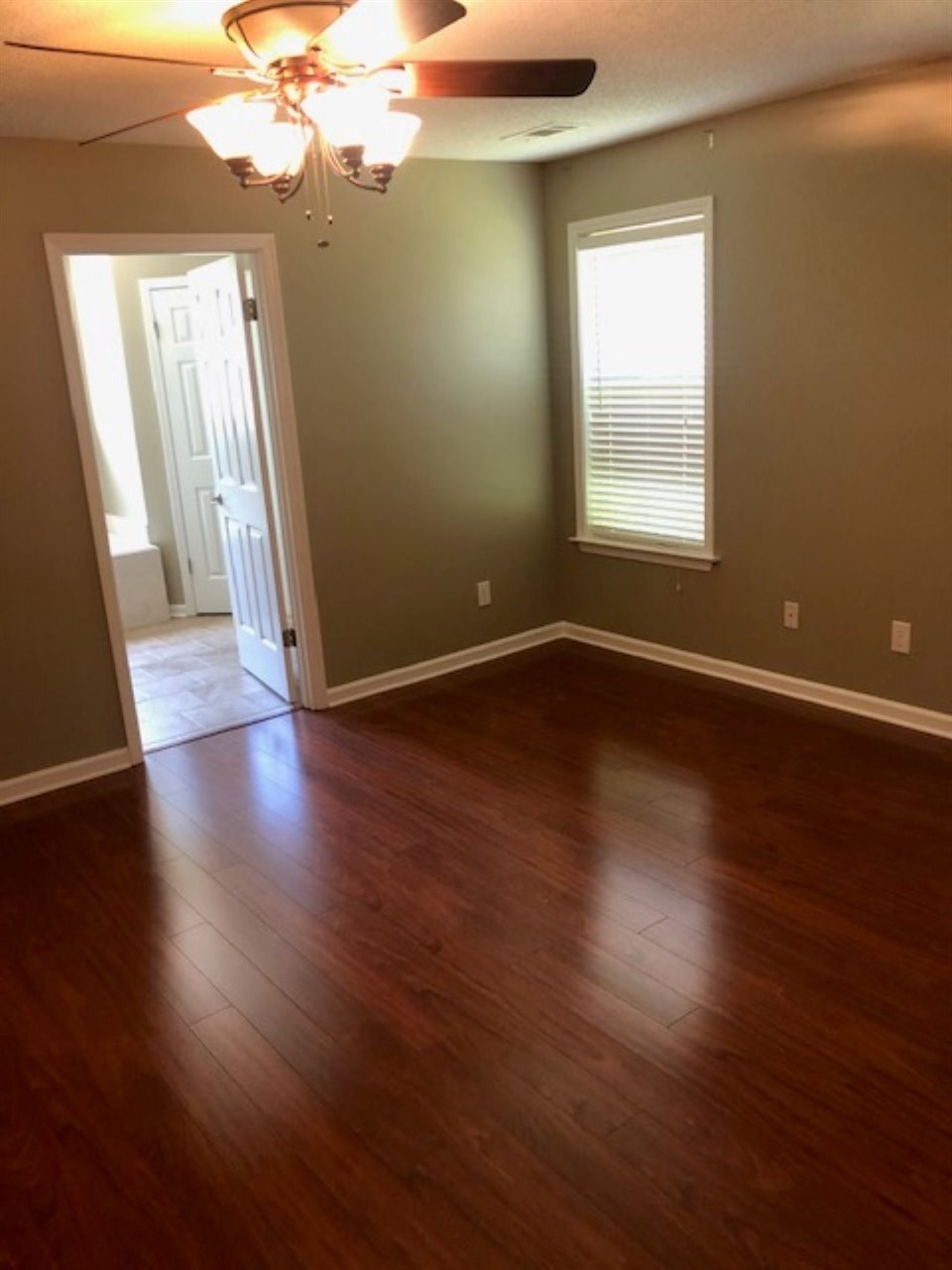 1386 Milestone Circle Collierville, TN 38017 - Photo 9 of 16 an empty room with wooden floor and windows