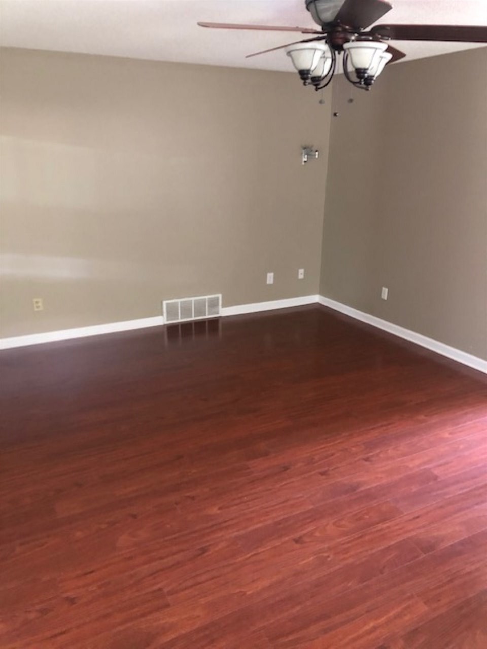 1386 Milestone Circle Collierville, TN 38017 - Photo 10 of 16 a view of a room with wooden floor and a ceiling fan