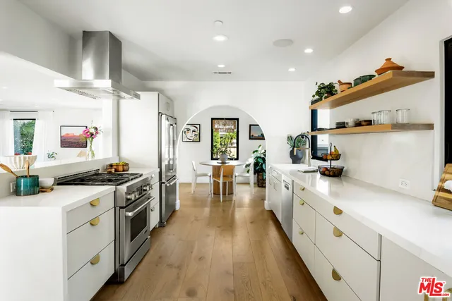 a kitchen with stove a sink and refrigerator