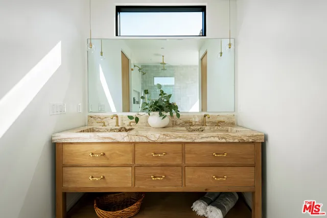 a bathroom with a granite countertop sink a mirror and a