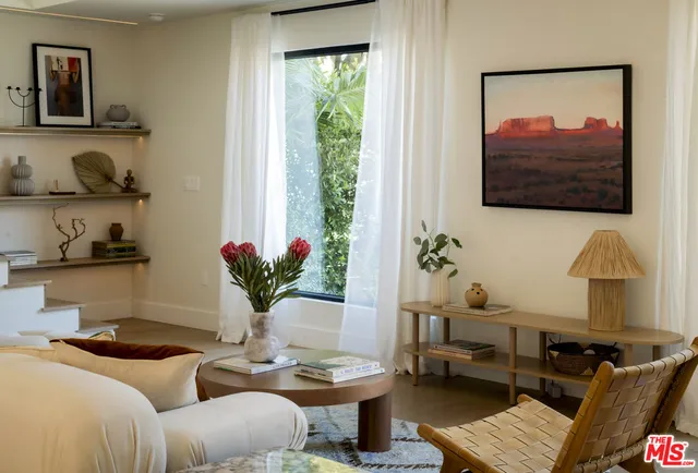a living room with furniture and a potted plant
