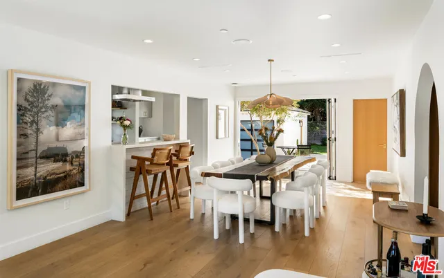 a dining room with furniture water view and wooden floor